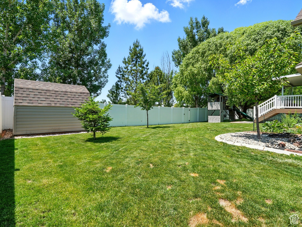 View of yard with a wooden deck