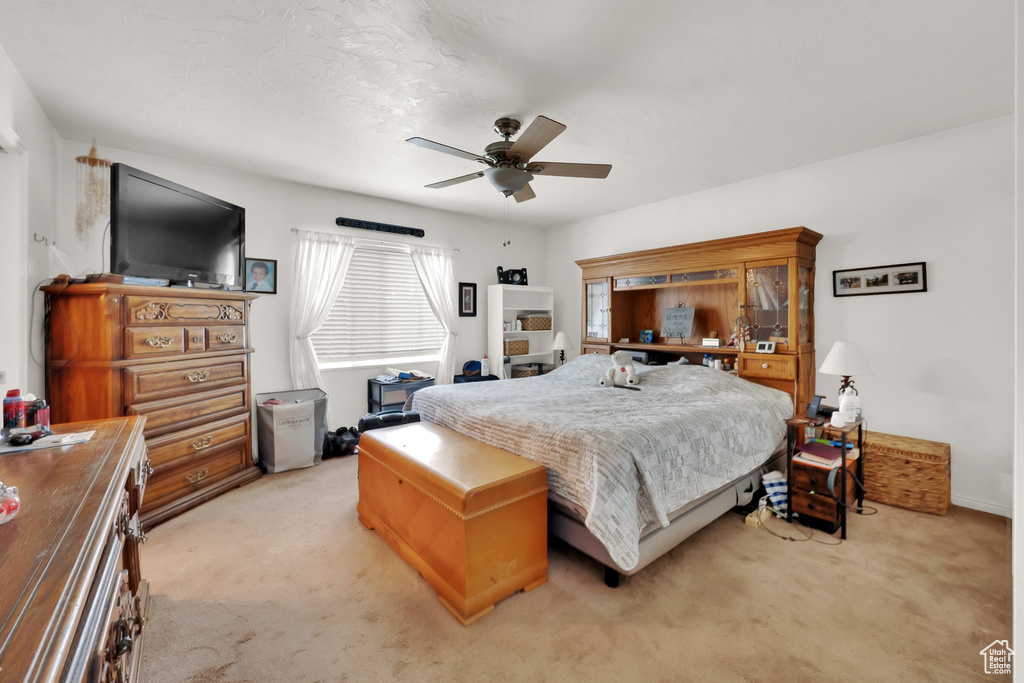 Bedroom featuring light carpet and ceiling fan