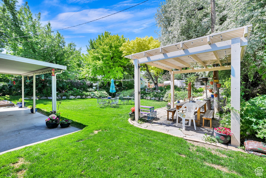 View of yard with a pergola and a patio area