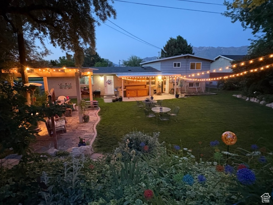 Rear view of house with a patio, a pergola, a yard, and a jacuzzi