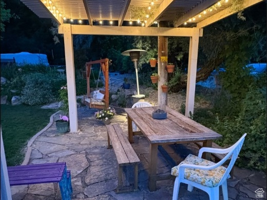 View of patio with a pergola and outdoor dining area