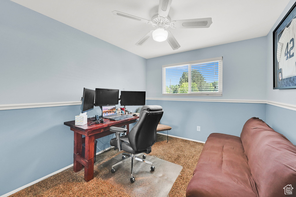 Office with carpet flooring, baseboards, and a ceiling fan