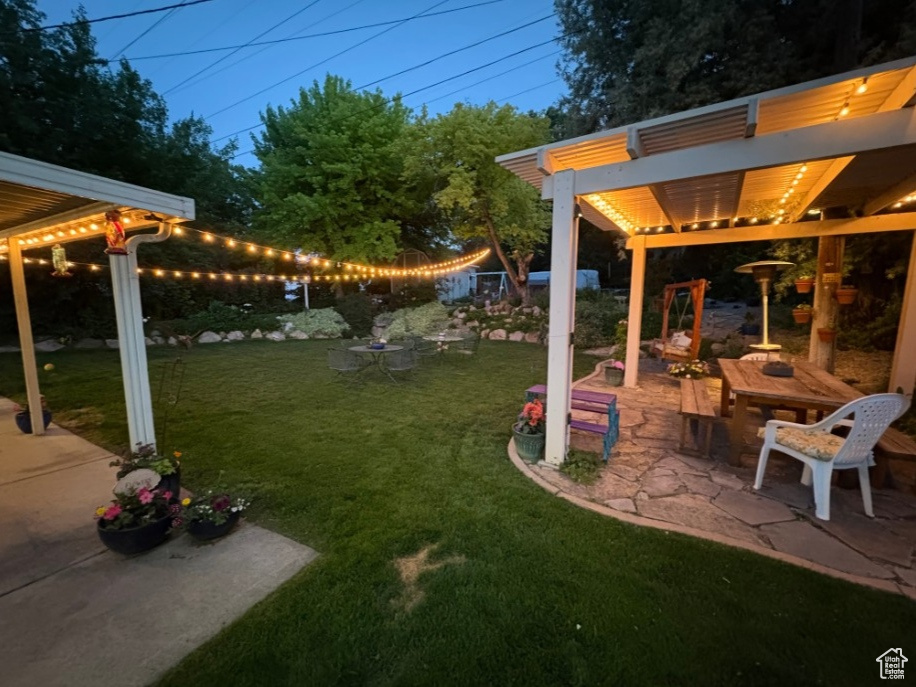 View of grassy yard with a patio