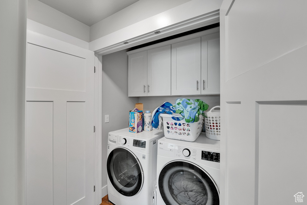 Washroom with cabinet space and washer and dryer