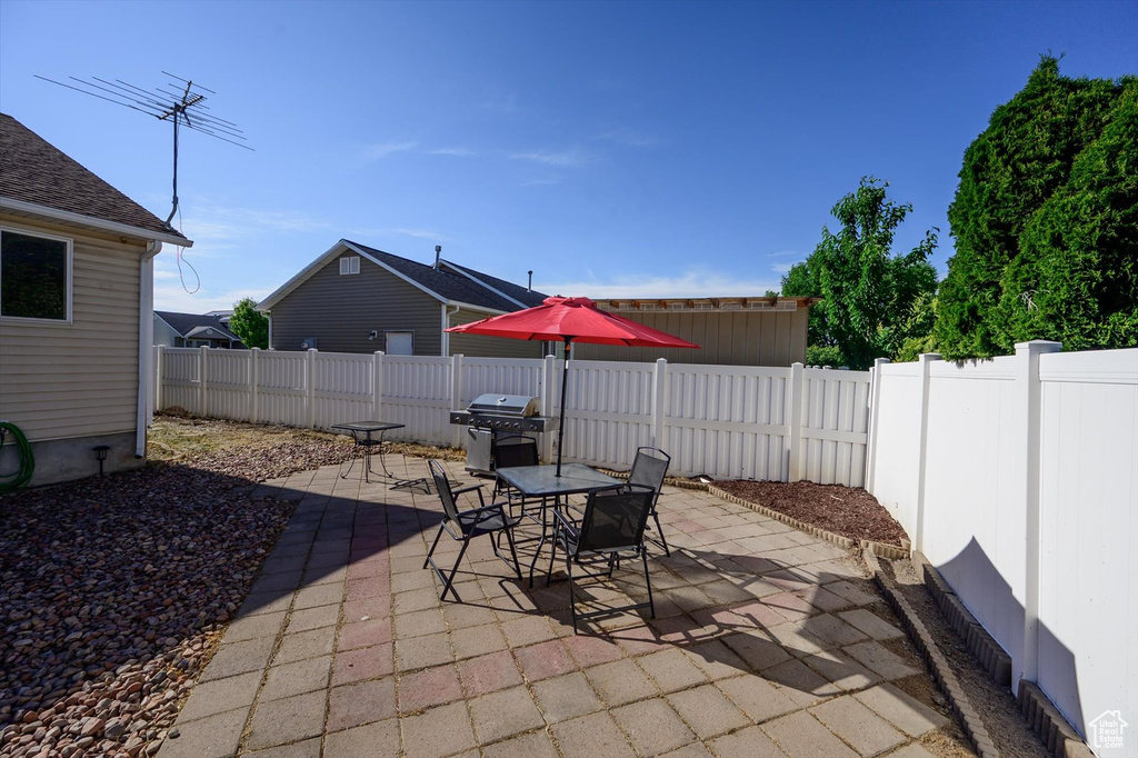 Fenced backyard featuring a patio, area for grilling, and outdoor dining area