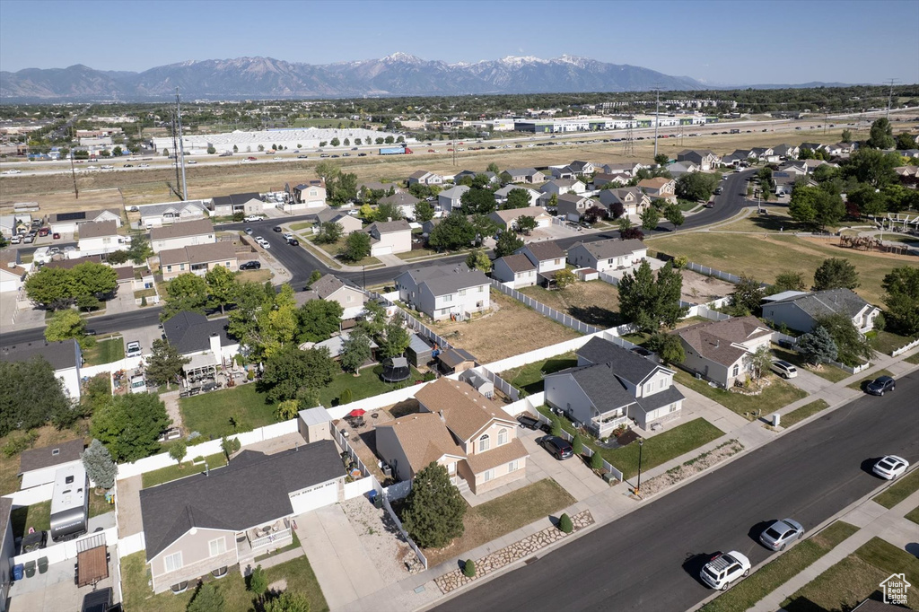 Aerial view of property's location featuring a mountain backdrop and nearby suburban area