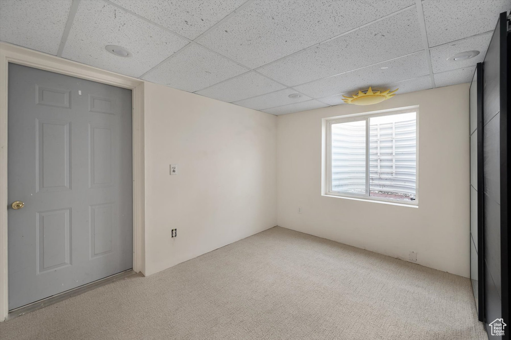 Unfurnished bedroom featuring a paneled ceiling and carpet floors