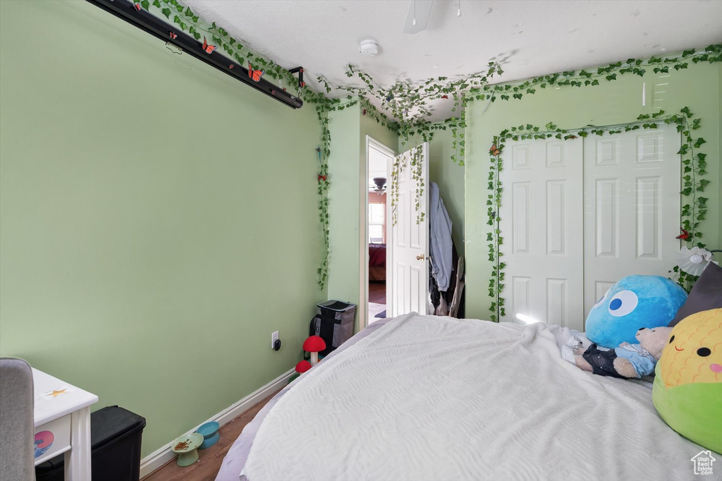 Bedroom featuring a closet, wood finished floors, and baseboards