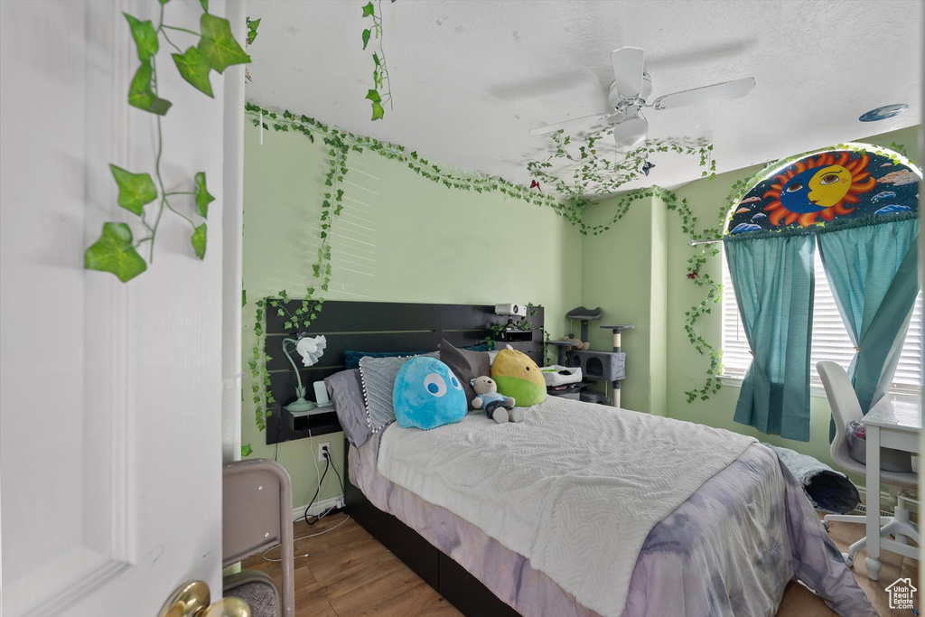 Bedroom with wood finished floors and ceiling fan