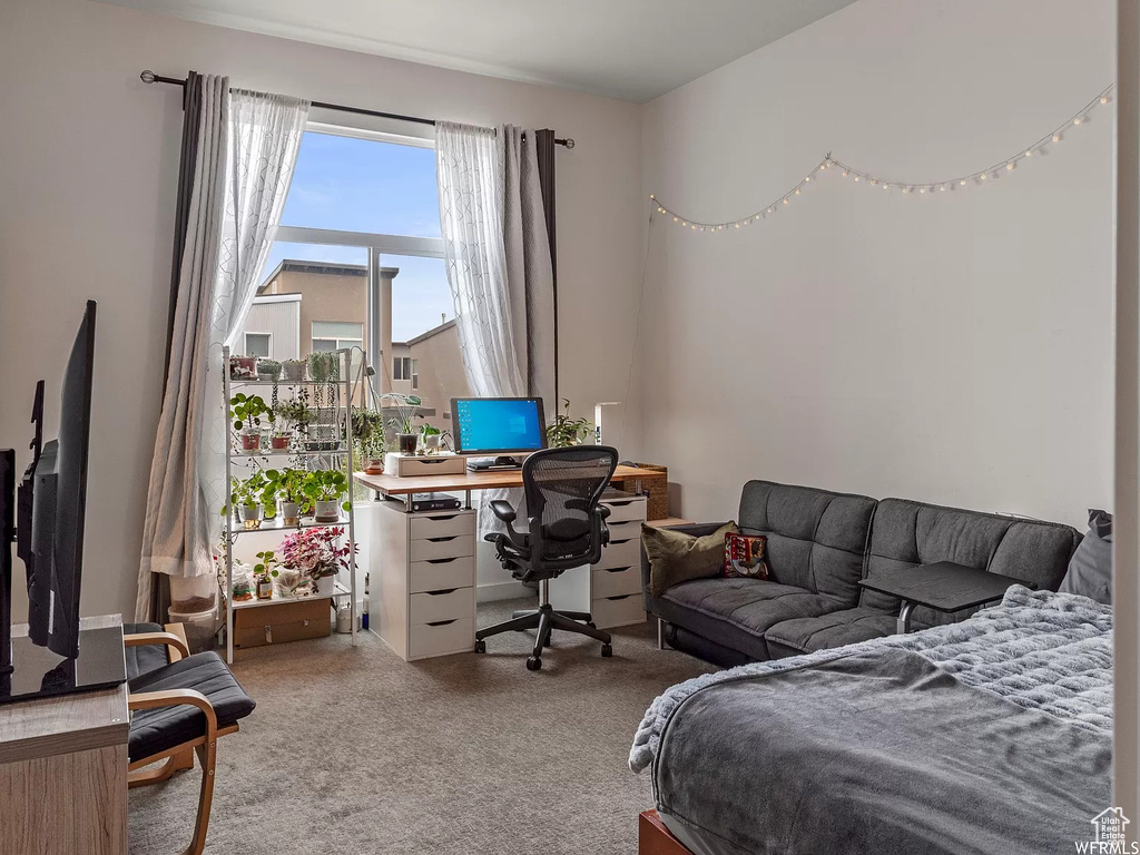 Bedroom with carpet and a desk