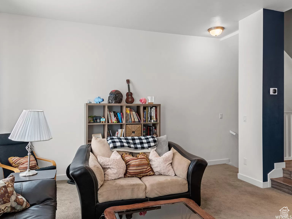 Carpeted living room featuring baseboards