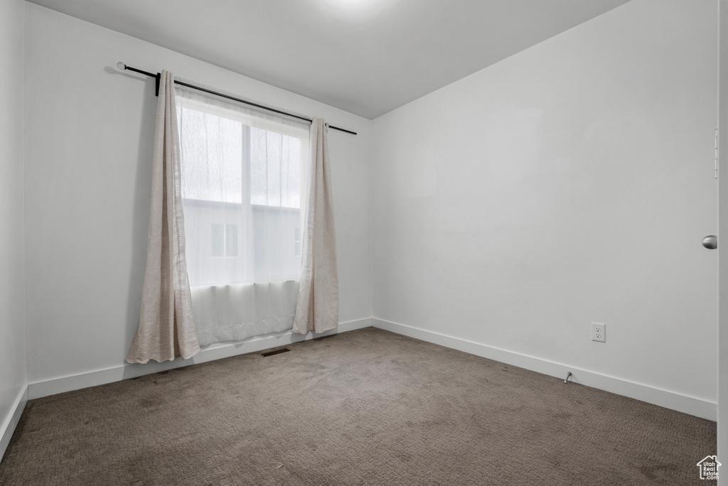 Unfurnished room featuring carpet flooring and baseboards