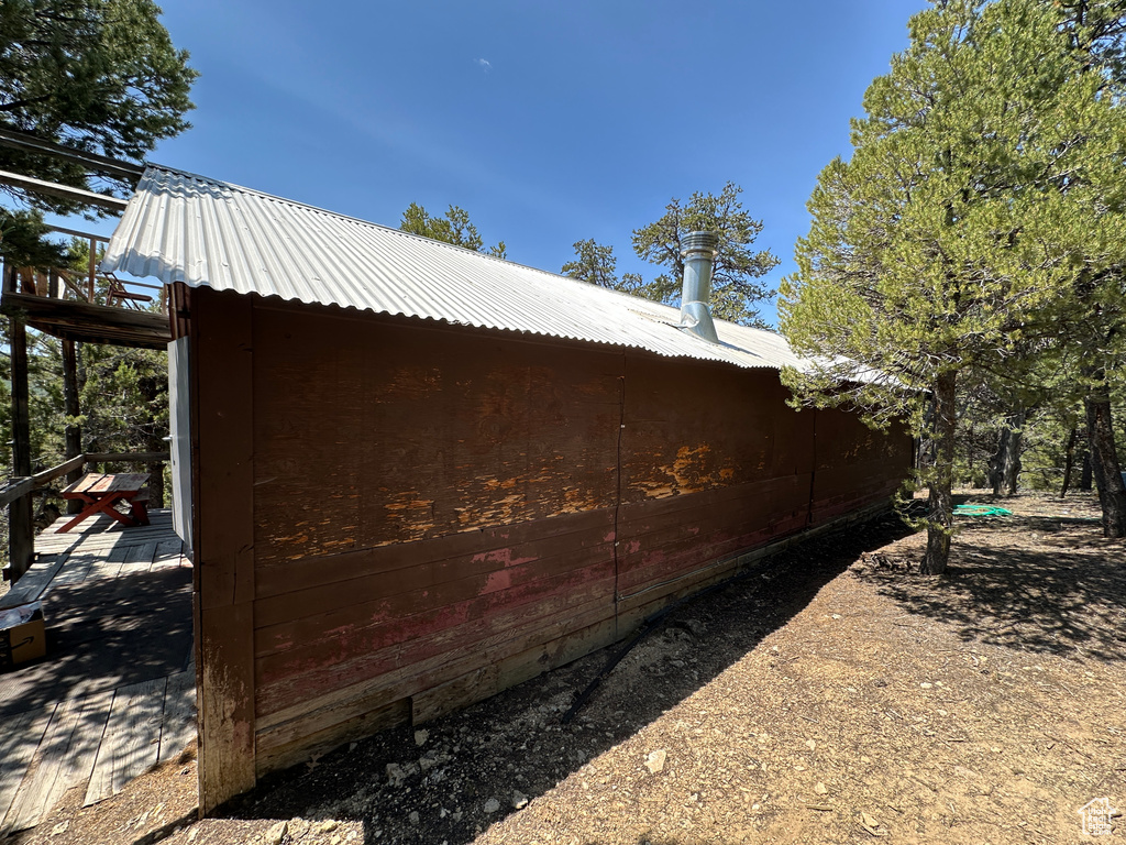 View of side of home featuring metal roof