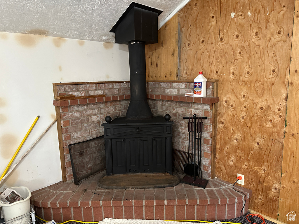 Detailed view of a wood stove and a textured ceiling
