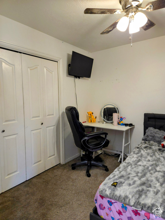 Bedroom with carpet floors, a closet, and a ceiling fan