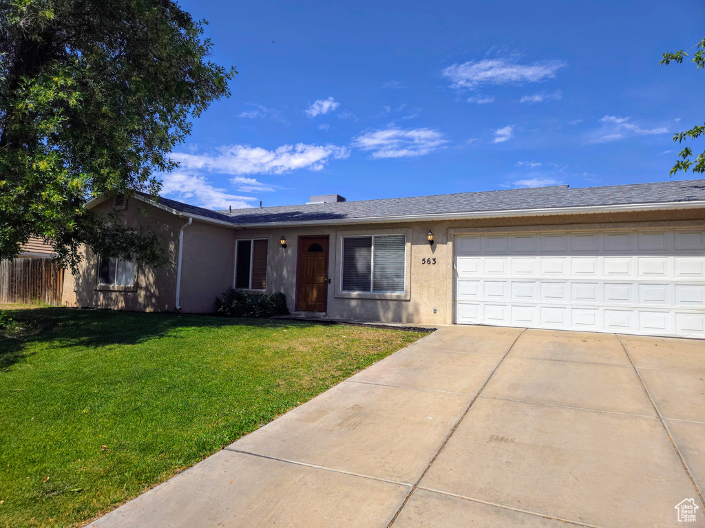Single story home with concrete driveway, a garage, and stucco siding