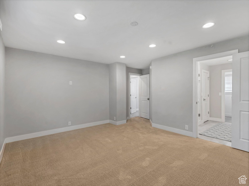 Unfurnished bedroom featuring recessed lighting, light carpet, and baseboards