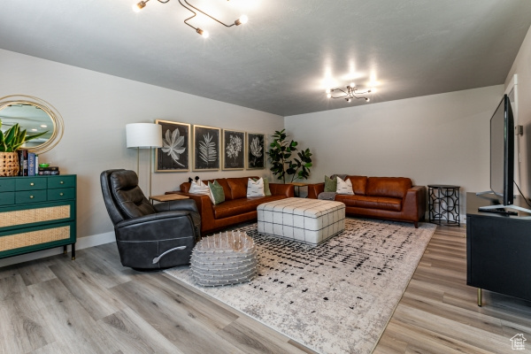 Living area with light wood-style floors and baseboards