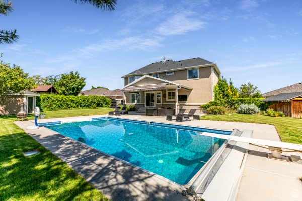 View of swimming pool with a patio, a diving board, and an outdoor living space