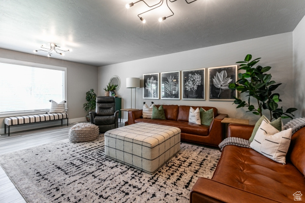 Living area with wood finished floors and baseboards