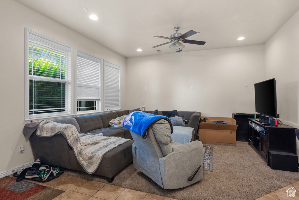 Living room featuring ceiling fan, light tile patterned floors, and recessed lighting