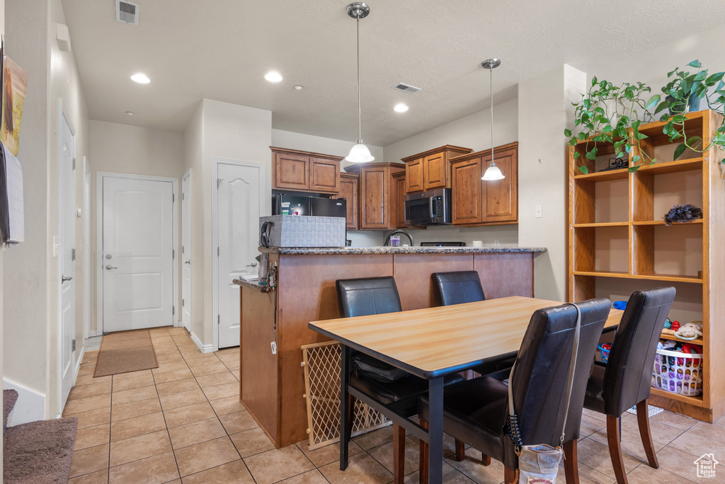 Dining room featuring light tile patterned floors, recessed lighting, and baseboards
