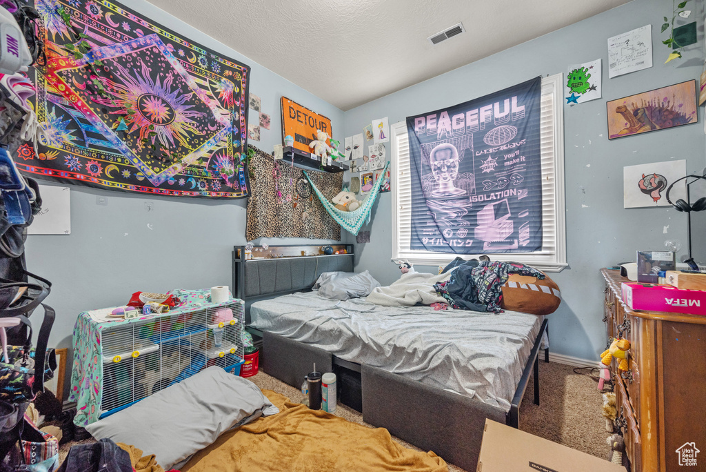 Bedroom featuring carpet flooring and baseboards