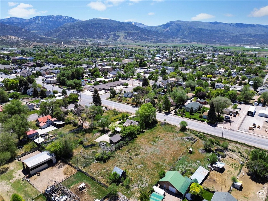 Aerial view of property's location with a mountainous background and nearby suburban area