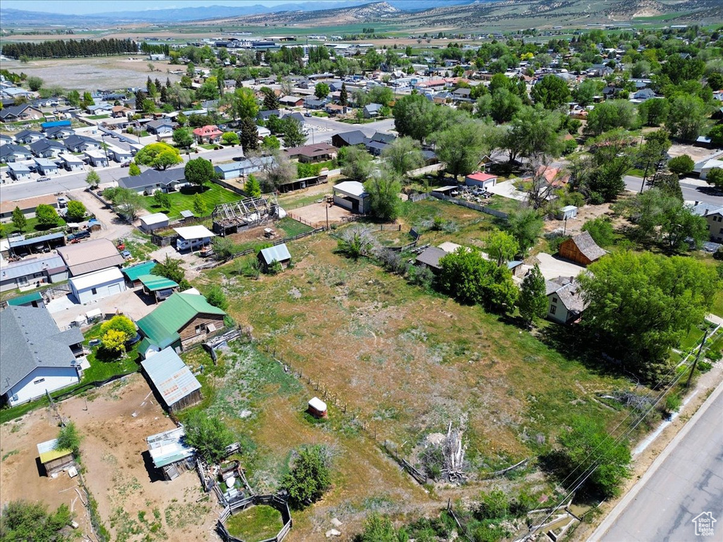 Aerial overview of property's location with a mountain backdrop and nearby suburban area