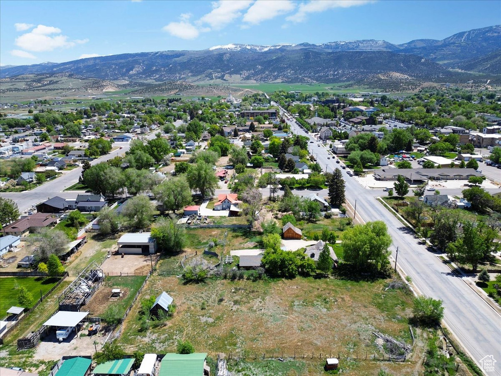 Aerial overview of property's location with a mountain backdrop and nearby suburban area