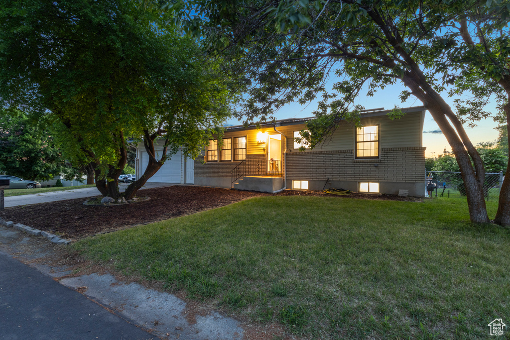 View of front of house featuring brick siding and driveway