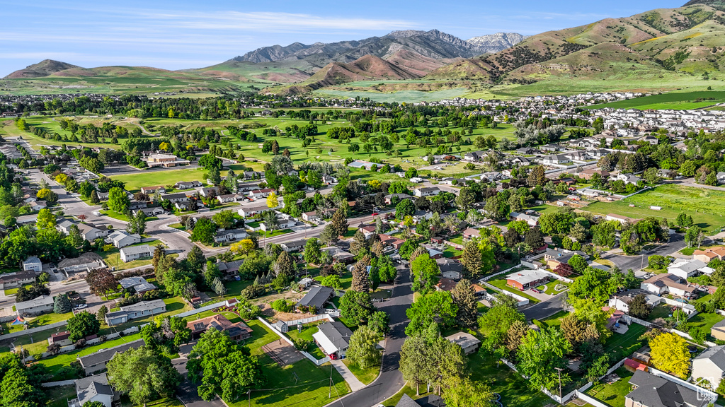Aerial view of property's location featuring a mountain backdrop and nearby suburban area