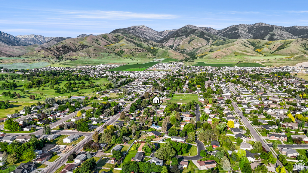 Aerial view of property's location featuring mountains and nearby suburban area
