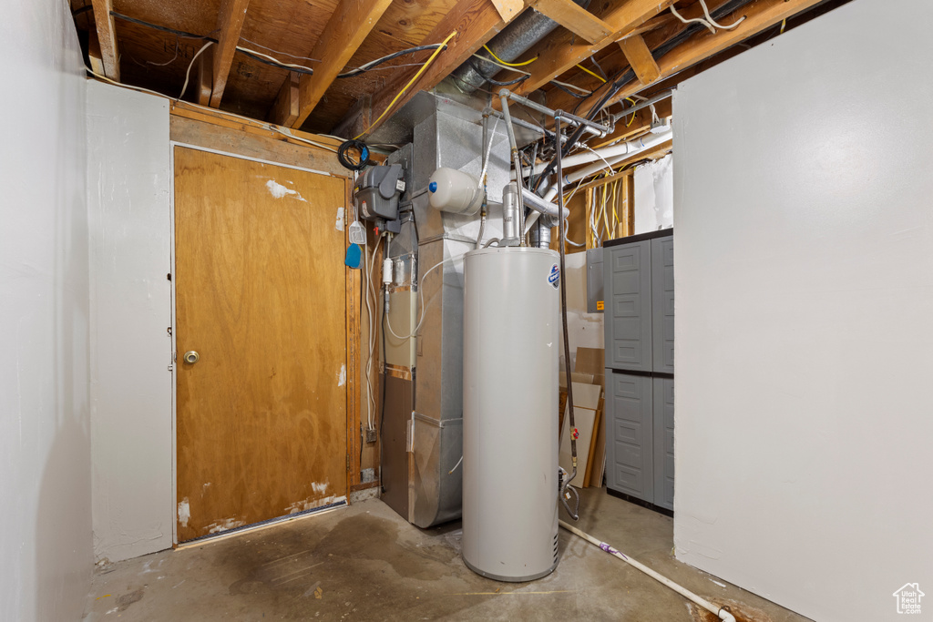 Utility room with gas water heater and heating unit