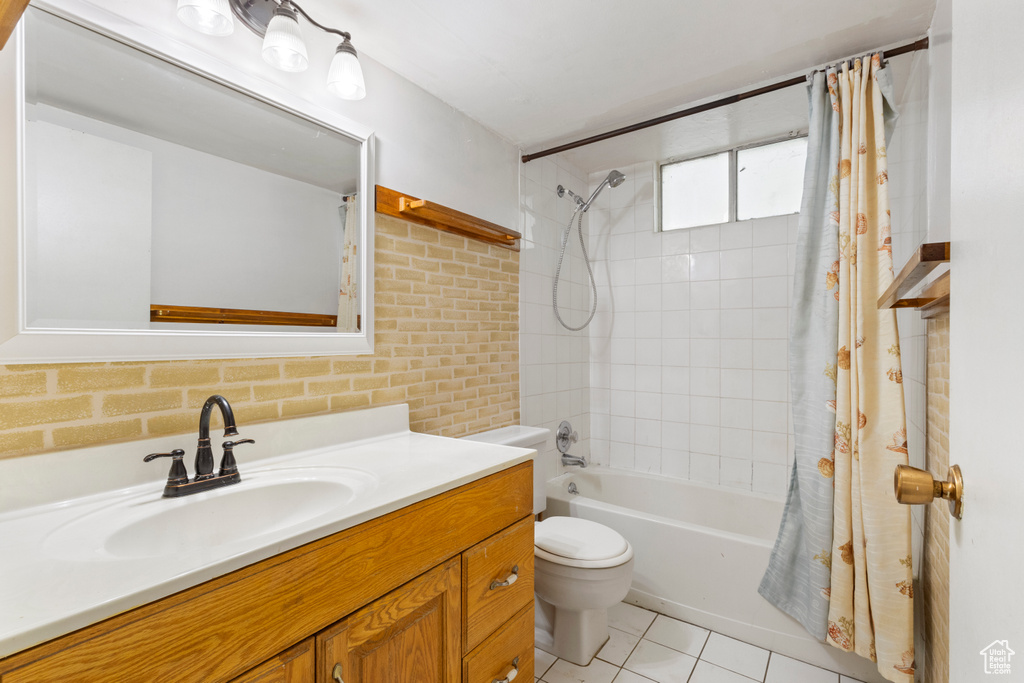 Full bath with vanity, toilet, shower / bathtub combination with curtain, and tile patterned floors
