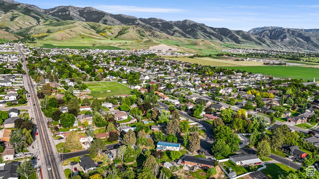 Aerial overview of property's location with mountains and nearby suburban area