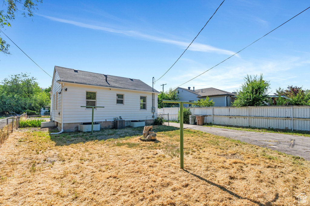 Rear view of house with cooling unit