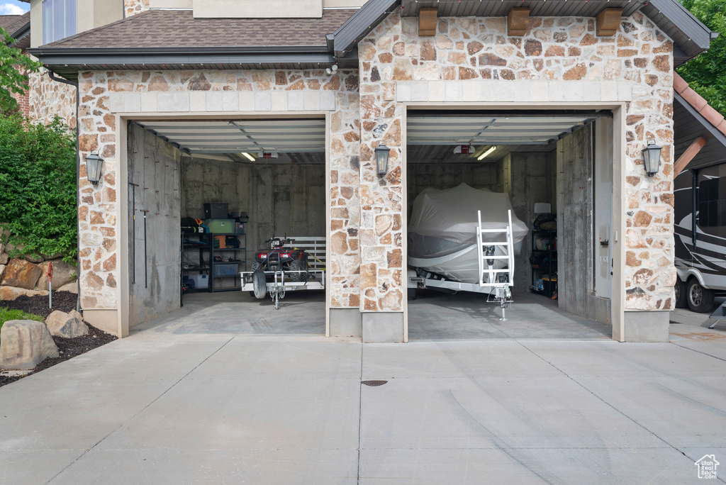 Garage featuring concrete driveway