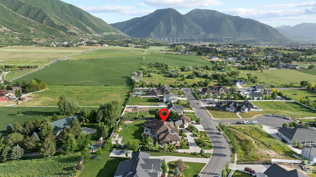 Aerial view of property's location featuring mountains and nearby suburban area