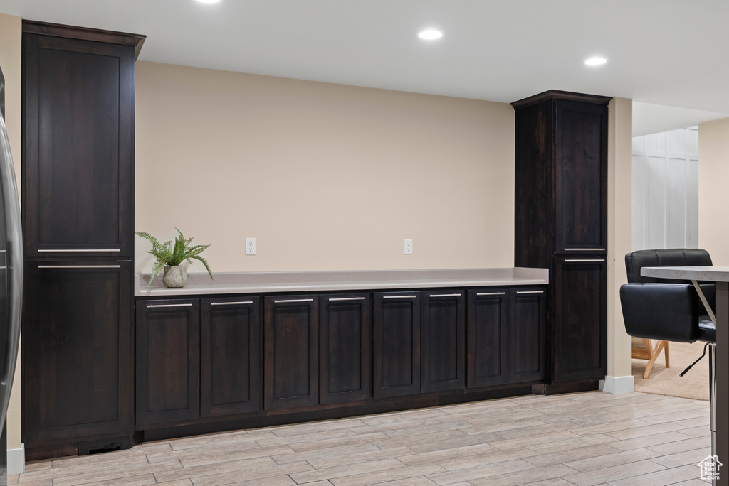 Kitchen with light countertops, recessed lighting, and light wood-type flooring