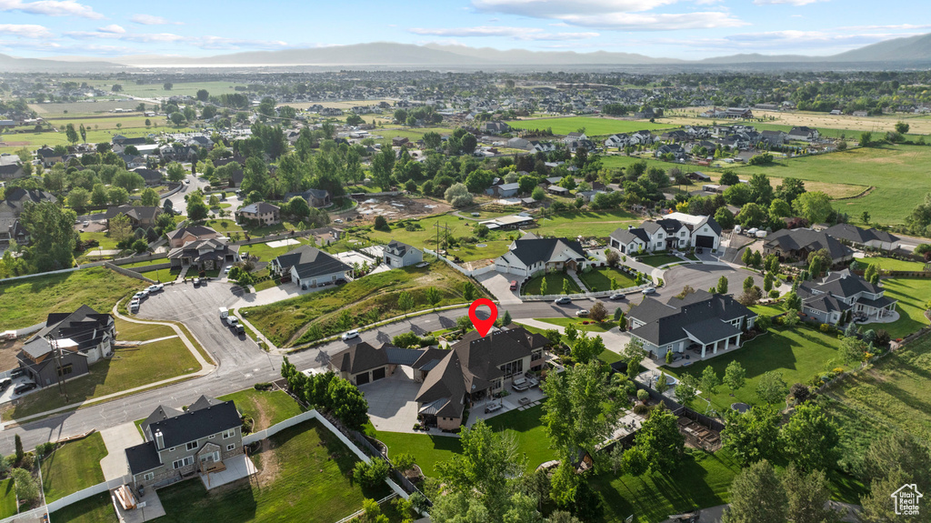 Aerial view of property's location featuring mountains and nearby suburban area