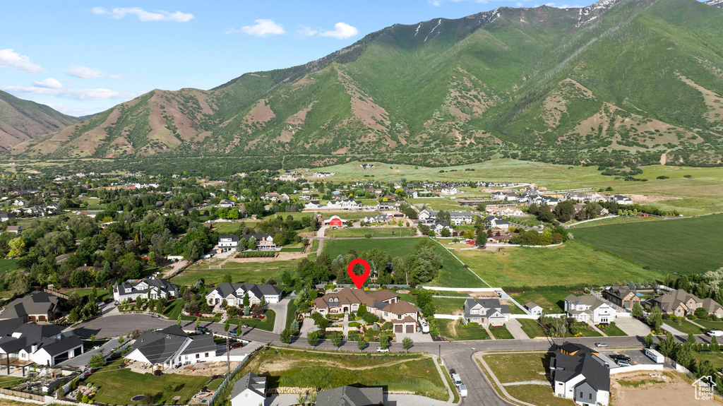 View of property location featuring mountains and nearby suburban area