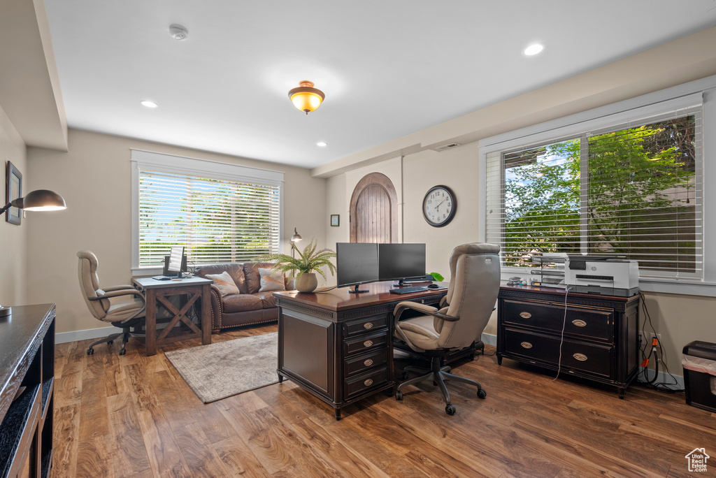 Office with plenty of natural light, wood finished floors, recessed lighting, and baseboards