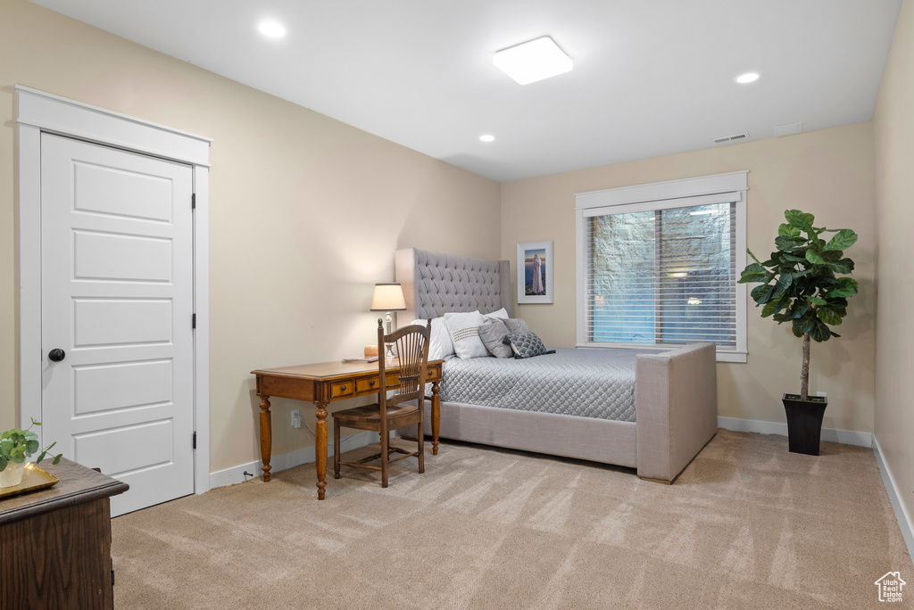 Bedroom featuring light carpet, baseboards, and recessed lighting