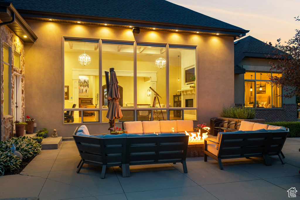Patio terrace at dusk featuring an outdoor living space and a patio