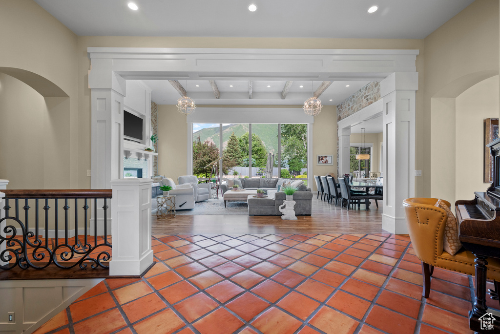 Living room with recessed lighting, beam ceiling, tile patterned flooring, and a fireplace
