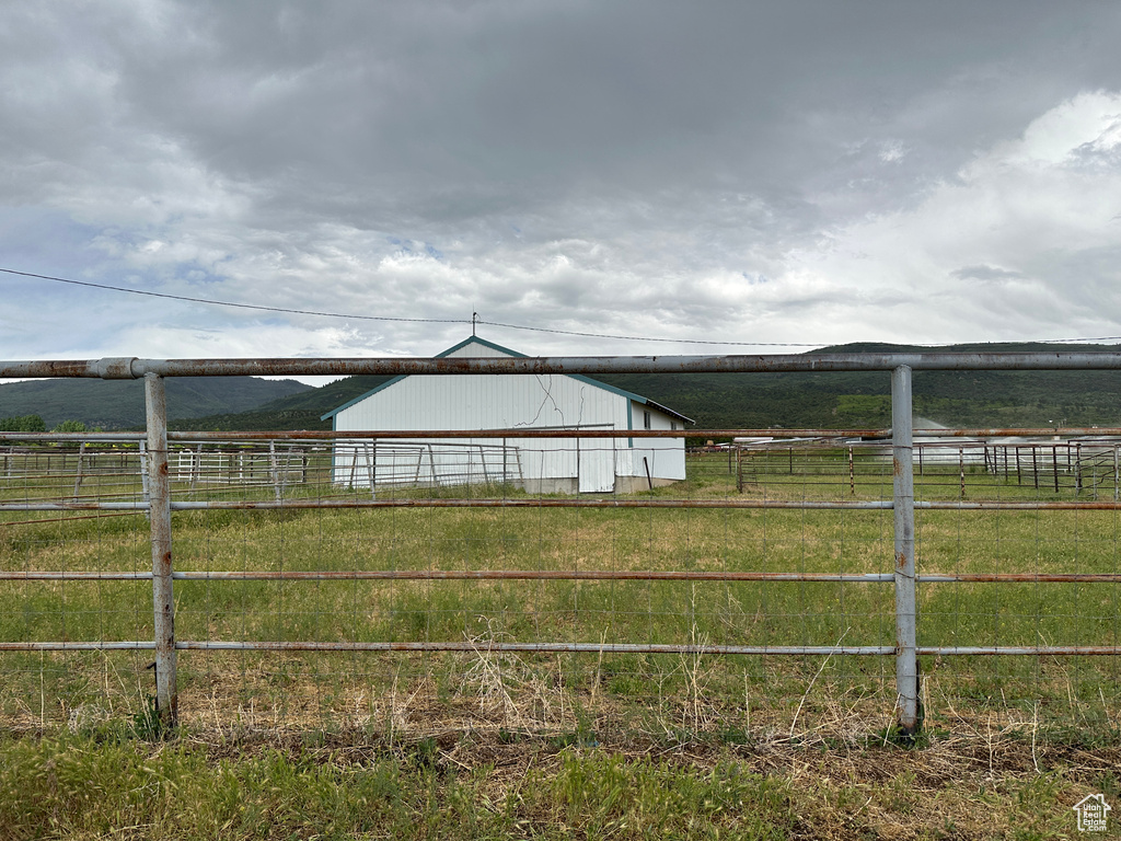 View of yard with a rural view, a pole building, and an outdoor structure
