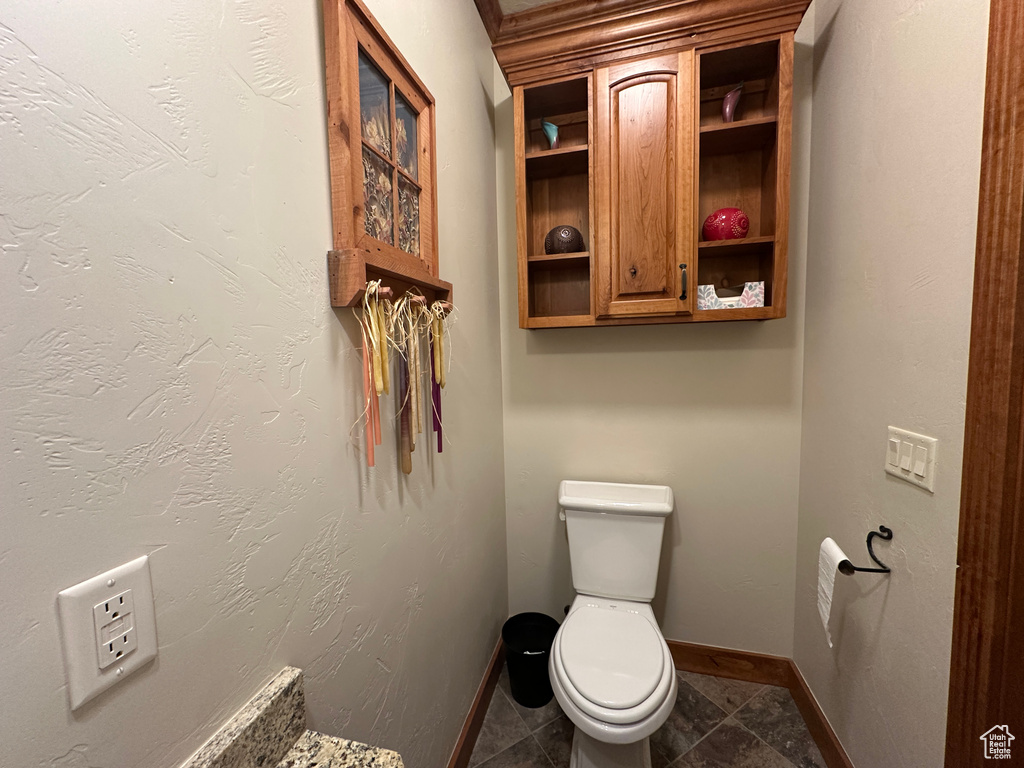 Bathroom featuring toilet and baseboards