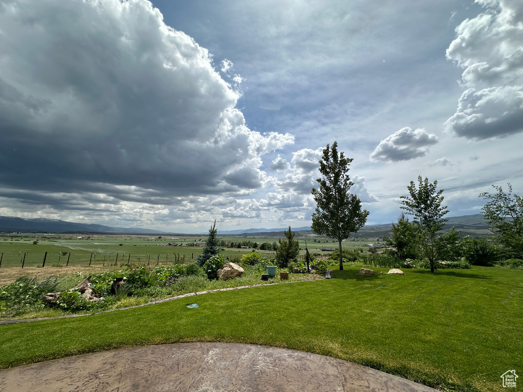 View of yard with a rural view and a mountain view