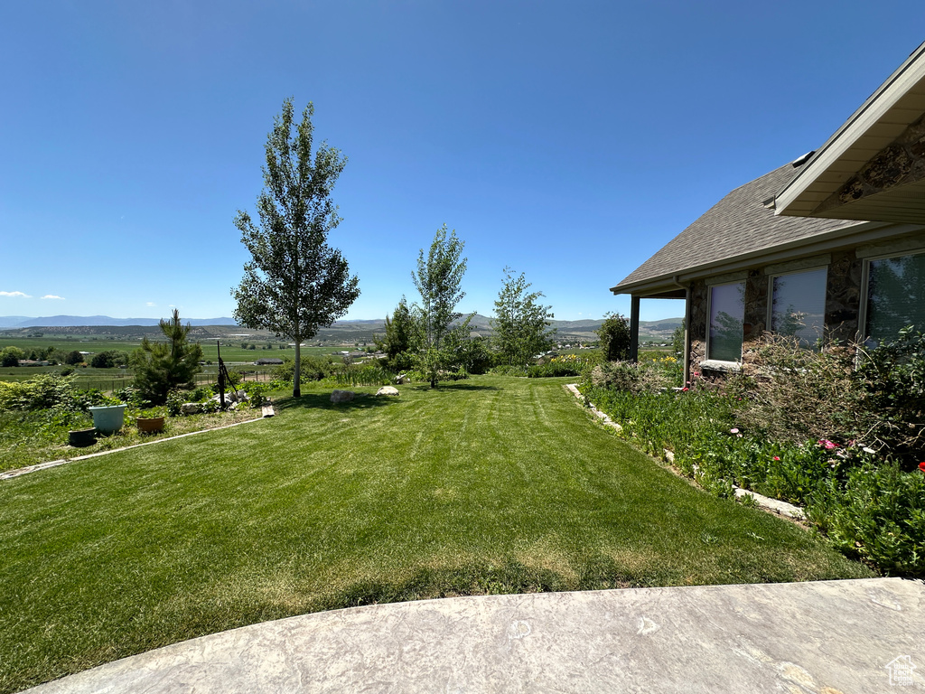 View of grassy yard featuring a mountain view